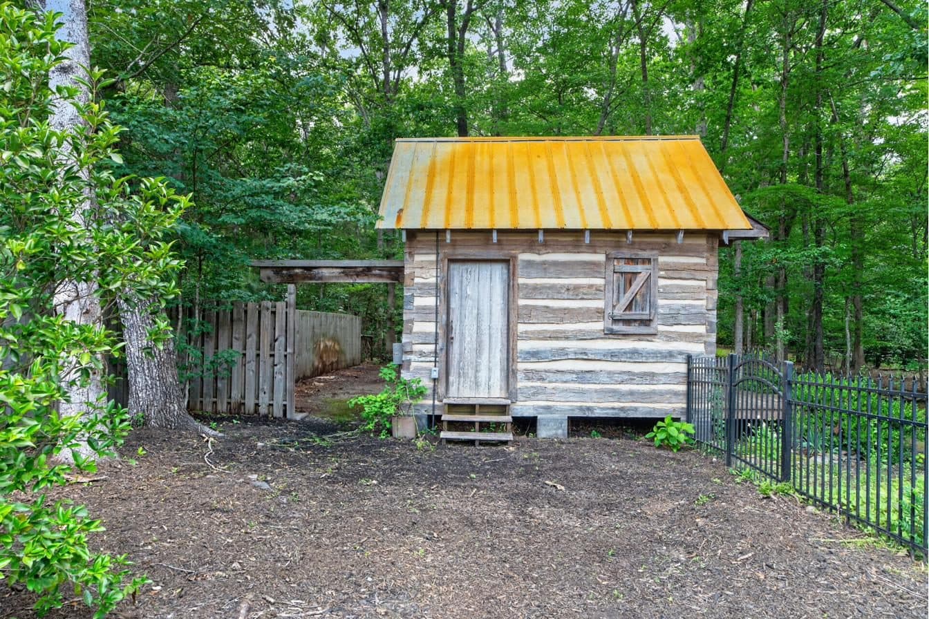 Heritage cabin on the rear compound parcel — A 150 sq ft heritage cabin, painstakingly reassembled from reclaimed timbers, with electrical service.